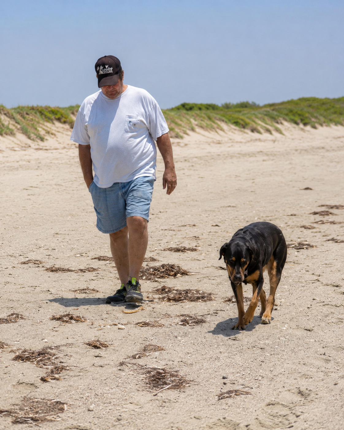 Jimbo walking his dog on the beach