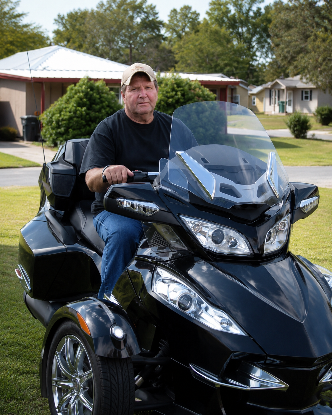 Jimbo seated on his black touring trike