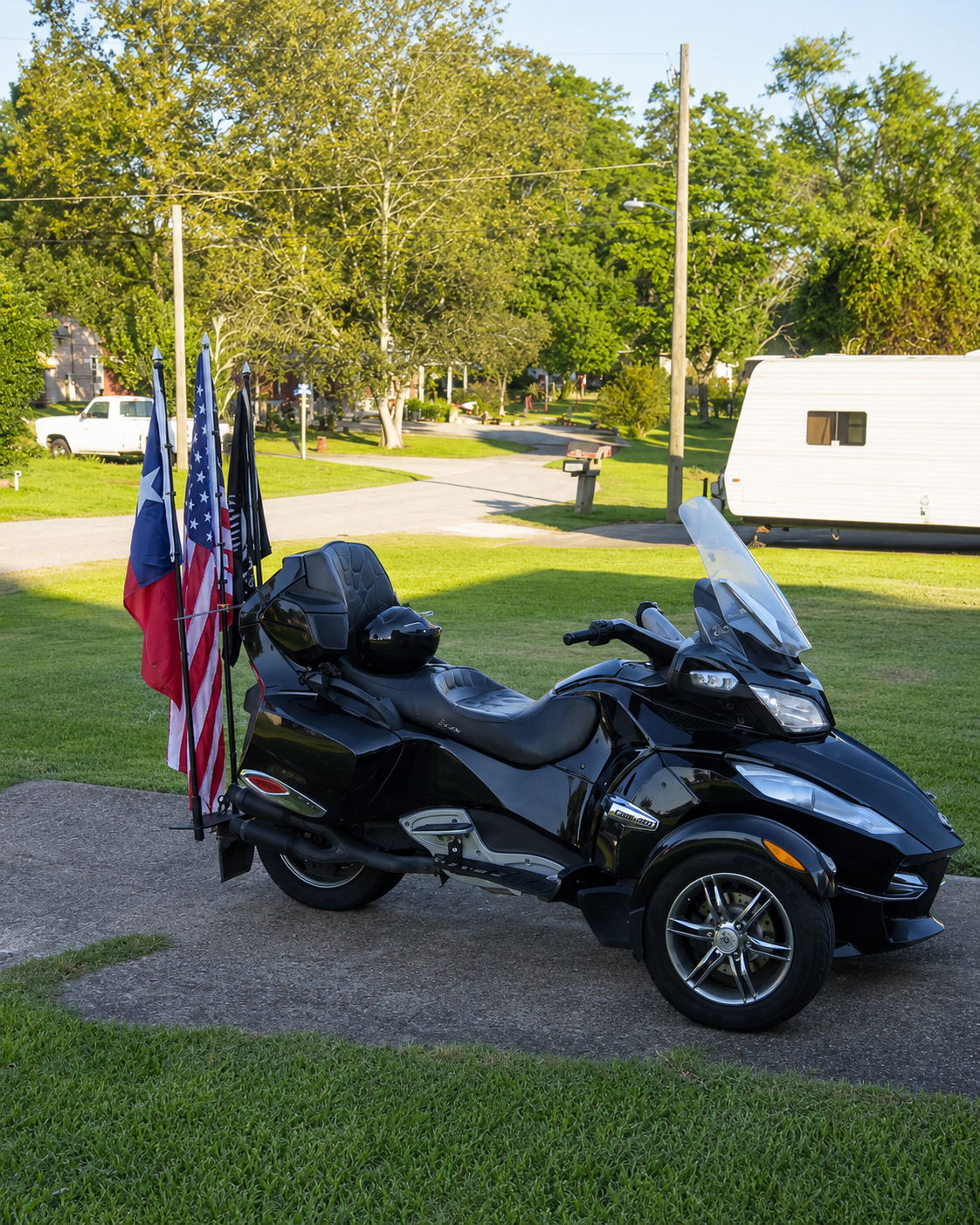 Touring trike parked with American flags